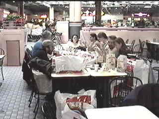 The group takes lunch in the mall&rsquo;s food court.