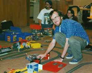 Chris Tracey adds cars to the track.